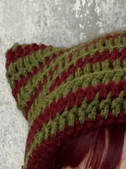Striped knitted hat with handmade horn detail