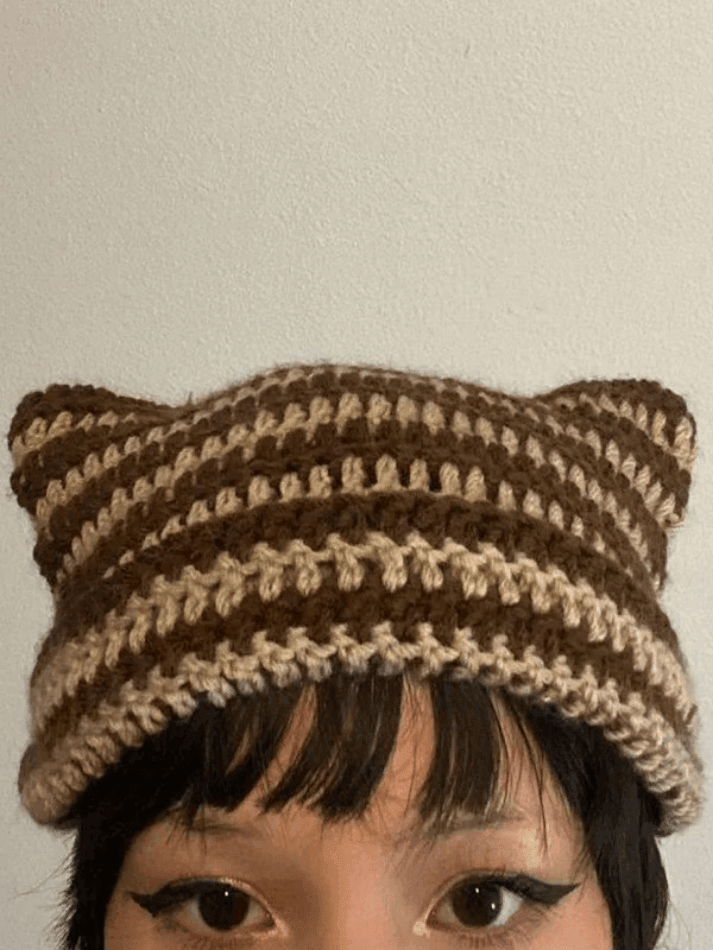 Striped knitted hat with handmade horn detail