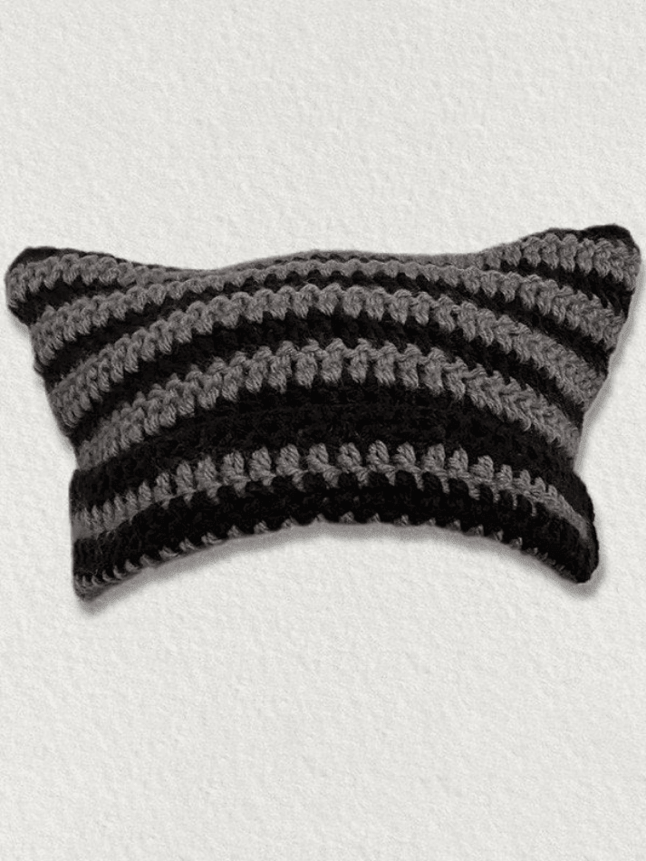 Striped knitted hat with handmade horn detail