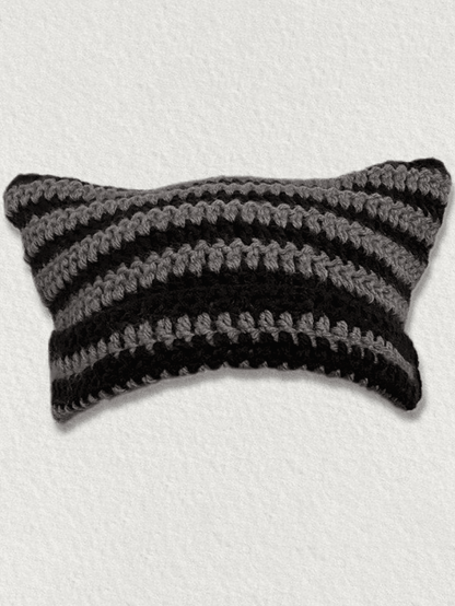 Striped knitted hat with handmade horn detail