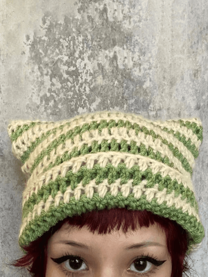 Striped knitted hat with handmade horn detail