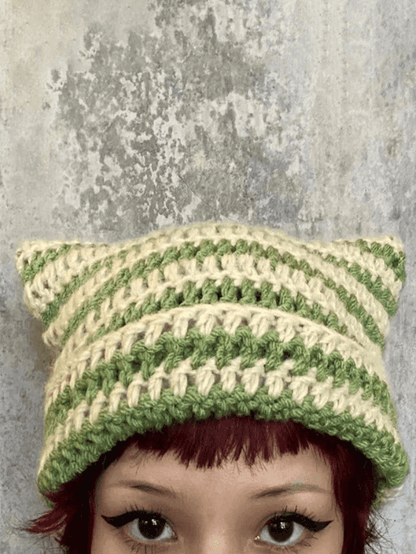 Striped knitted hat with handmade horn detail