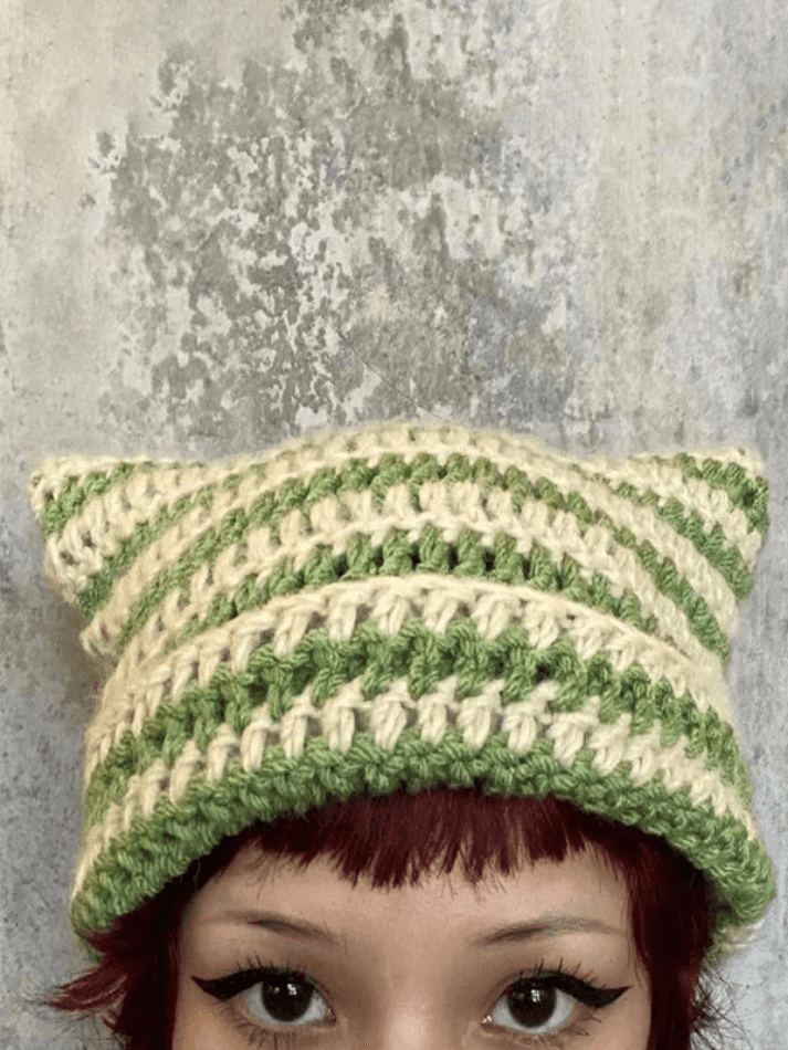 Striped knitted hat with handmade horn detail