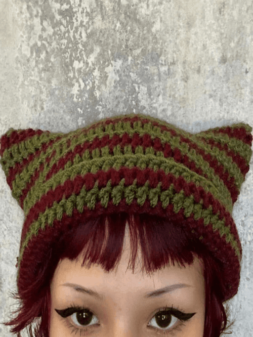 Striped knitted hat with handmade horn detail