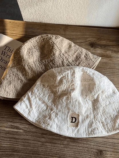 Ruched bucket hat with embroidered letters