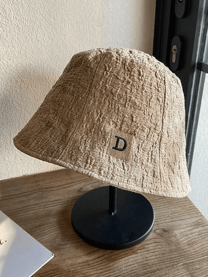 Ruched bucket hat with embroidered letters