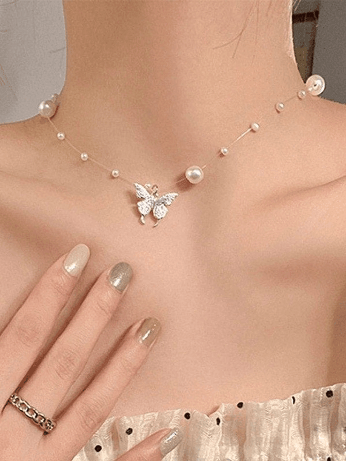 Faux pearl necklace with butterfly charm