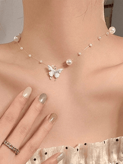 Faux pearl necklace with butterfly charm